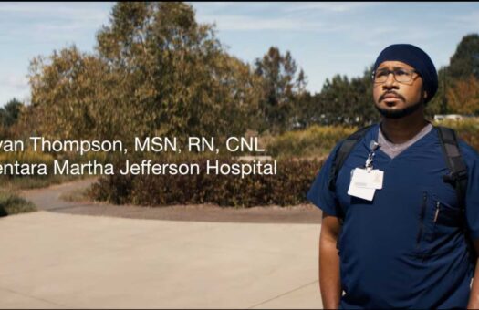 Nurse Ryan Thompson stands in front of Sentara Martha Jefferson Hospital