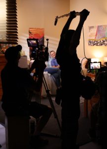 A boom operator and camera operator filming a scene